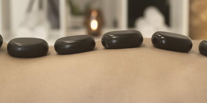 A row of dark heated stones resting along a back
